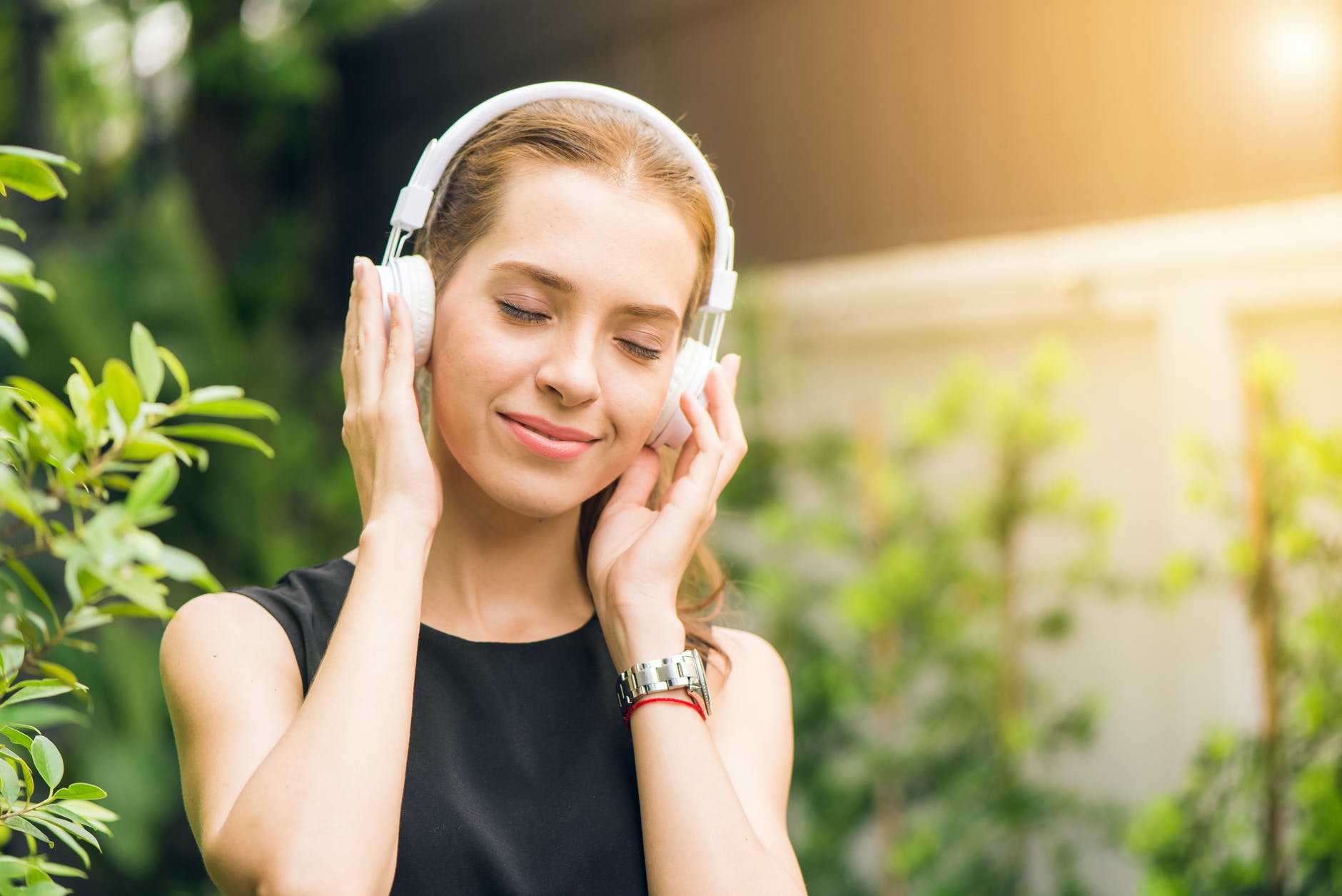 10 Daily habits that will change your life 7 woman wearing black sleeveless dress holding white headphone at daytime