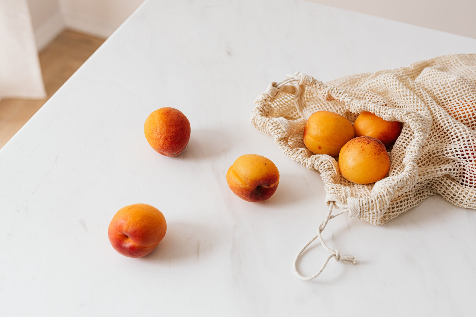 7 Antioxidant-rich fruits and its health benefits 3 organic sweet apricots in cotton sack placed on table