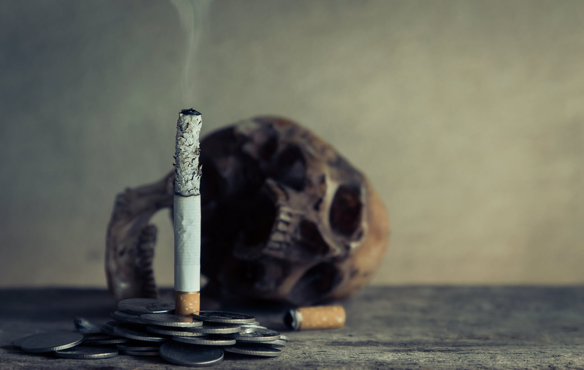 7 Bad Habits That Harm Your Brain’s Health 4 cigarette stick on pile of coins